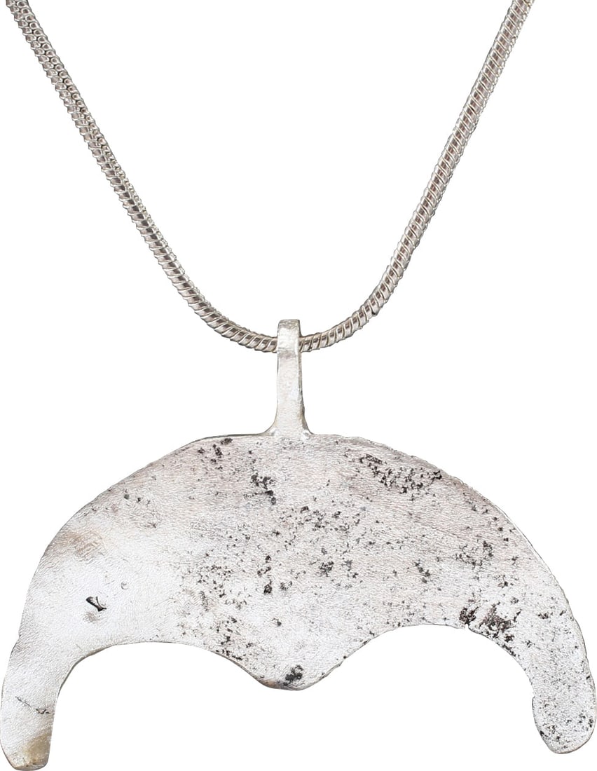 RARE VIKING LUNAR PENDANT NECKLACE, 9TH-10TH CENTURY AD: Slightly under 1 ½" (1.46") width. Bronze, cast, and chased as the crescent moon with broad raised edges and three radials. Viking worship involved the heavenly bodies on which they relied for gu