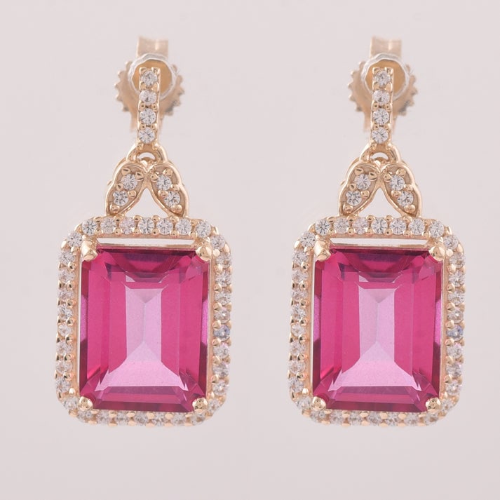 6.76 Ct Octagon Pink Topaz 9K Gold Earrings: 6.76 Total Carat Pink Topaz 9K Gold Earrings Specifications: Total Weight 3.289 Center Gemstone Pink Topaz Gemstone Carat Weight 6.4 Carats Gemstone Measurements 9X7 mm Additional Gemstones White Sapp