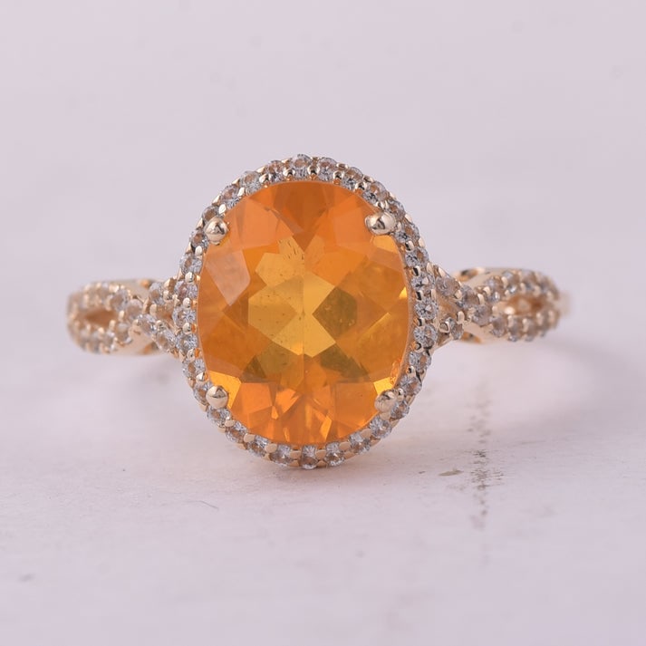 2.09 Ct Oval Br.Fire Opal 9K Gold Ring: 2.09 Total Carat Br.Fire Opal 9K Gold Ring Specifications: Total Weight 2.2 g Center Gemstone Br.Fire Opal Gemstone Carat Weight 1.83 Carats Gemstone Measurements 10X8 mm Additional Gemstones White Sa