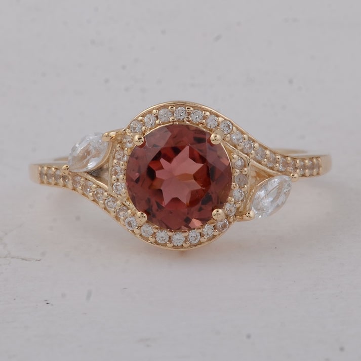 1.96 Ct Round Tourmaline 9K Gold Ring: 1.96 Total Carat Tourmaline 9K Gold Ring Specifications: Total Weight 2.47 g Center Gemstone Tourmaline Gemstone Carat Weight 1.57 Carats Gemstone Measurements 7 mm Additional Gemstones White Sapphire