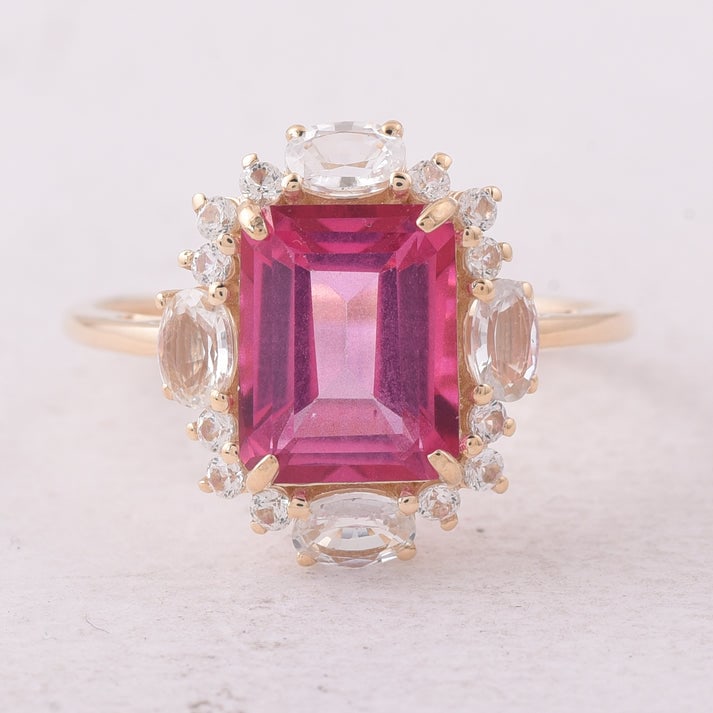 3.98 Ct Octagon Pink Topaz 9K Gold Ring: 3.98 Total Carat Pink Topaz 9K Gold Ring Specifications: Total Weight 2.456 g Center Gemstone Pink Topaz Gemstone Carat Weight 2.97 Carats Gemstone Measurements 9X7X4.80 mm Additional Gemstones White 