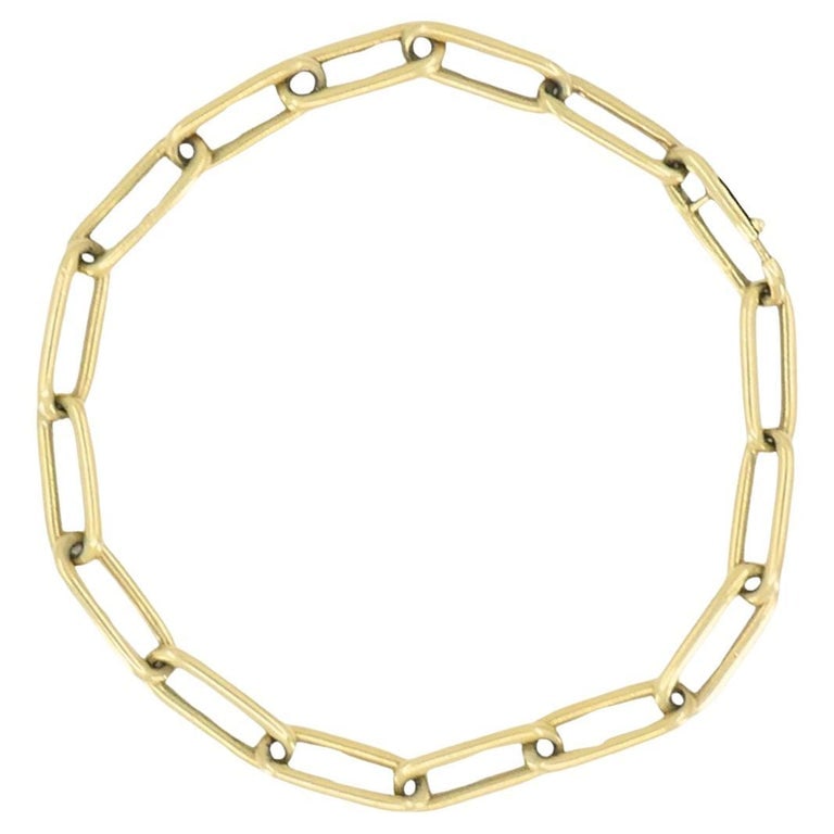 Vintage 14k Gold Paperclip Link Bracelet: Title: Vintage 14k Gold Paperclip Link Bracelet Description: This vintage Italian bracelet is crafted in 18K yellow gold and features a timeless paperclip link design. Each elongated link is slightly 