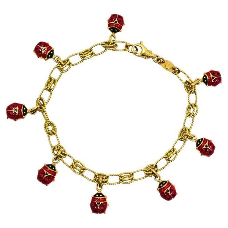 18k Gold Chain 14k Gold Enamel Ladybug Charms Bracelet: Title: 18k Gold Chain 14k Gold Enamel Ladybug Charms Bracelet Description: Playful yet luxurious, this vintage bracelet features an 18k gold double-link chain adorned with eight 14k red enamel ladybug