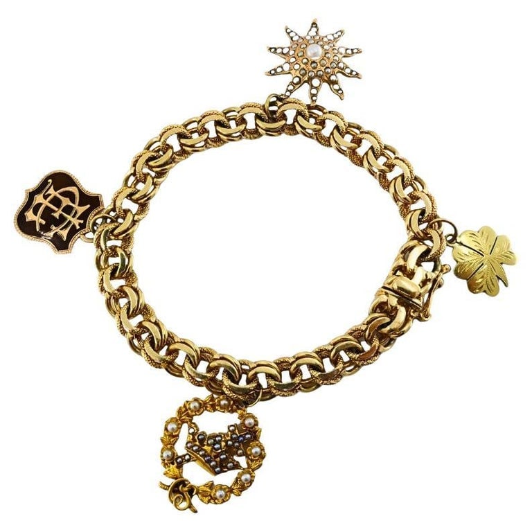 Victorian 14k Gold Link Bracelet Enamel Pearl & Engraved Charms: Title: Victorian 14k Gold Link Bracelet Enamel Pearl & Engraved Charms Description: This exquisite Victorian charm bracelet is crafted in 14k gold, featuring a substantial double link chain measuring 
