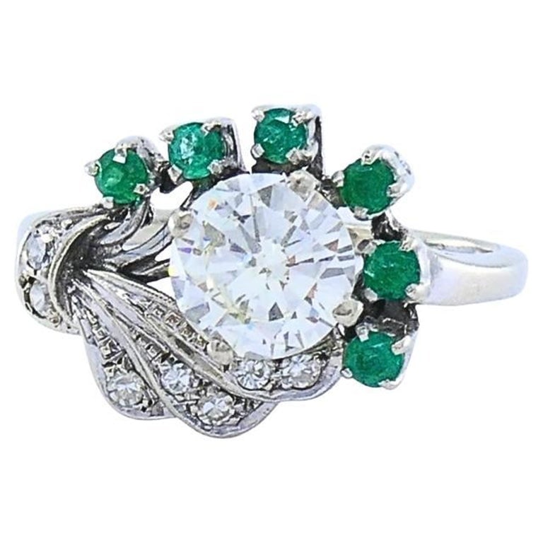 Vintage 14k White Gold Diamond Emerald Cocktail Ring: Title: Vintage 14k White Gold Diamond Emerald Cocktail Ring Description: A striking vintage cocktail ring crafted in 14K white gold, highlighting a dazzling diamond at its center. The lively green