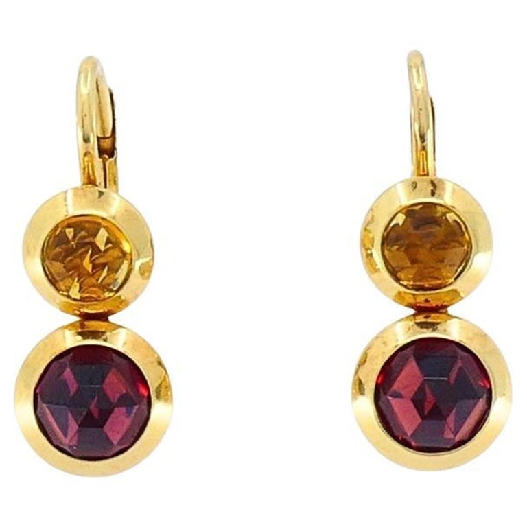Tiffany & Co. 18k Gold Garnet Citrine Drop Earrings: Title: Tiffany & Co. 18k Gold Garnet Citrine Drop Earrings Description: These exquisite drop earrings from Tiffany & Co., crafted in 18k yellow gold. Each earring features a vibrant bezel-set round