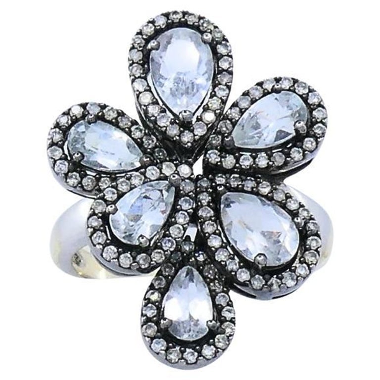 14k Gold Diamond Floral Cocktail Ring: Title: 14k Gold Diamond Floral Cocktail Ring Description: This striking 14k gold cocktail ring is crafted in a bold floral design, centering on six pear-shaped rose-cut diamonds, each arranged in a