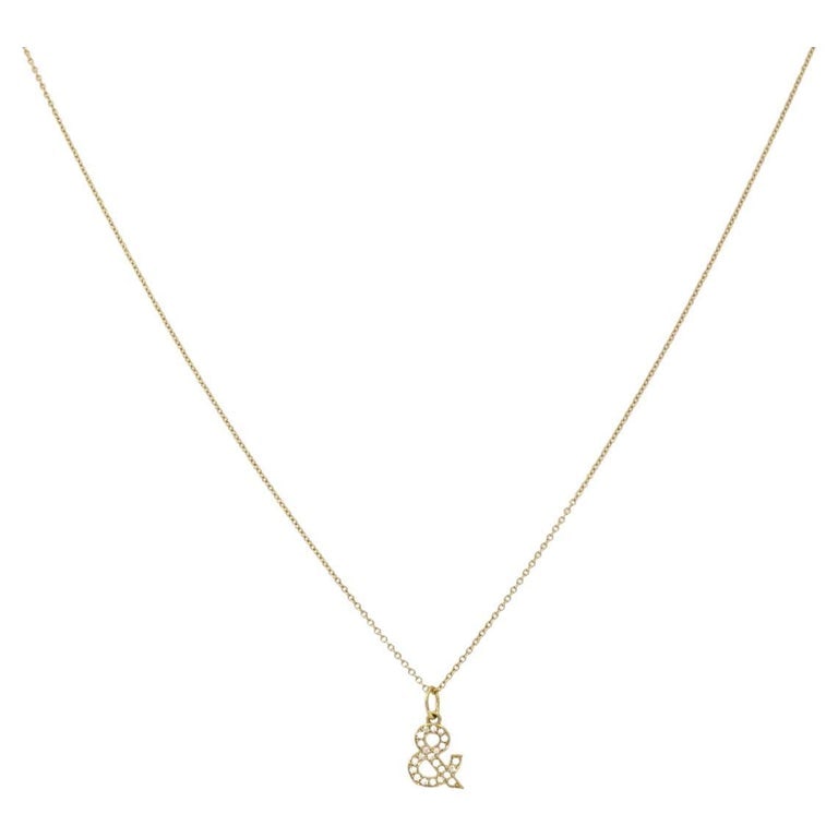 Tiffany & Co. Charm Pendant Necklace 18k Gold Diamond Ampersand Original Box: Title: Tiffany & Co. Charm Pendant Necklace 18k Gold Diamond Ampersand Original Box Description: This Tiffany & Co. diamond necklace features a delicate ampersand charm, set with pavÃ©