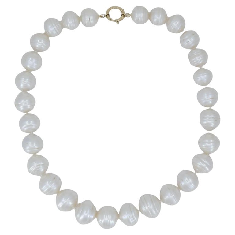 Vintage 14k Gold Baroque Cultured Pearl Necklace: Title: Vintage 14k Gold Baroque Cultured Pearl Necklace Description: This circa 1990s baroque pearl necklace features 28 lustrous freshwater cultured pearls strung in a continuous strand. Each pearl i