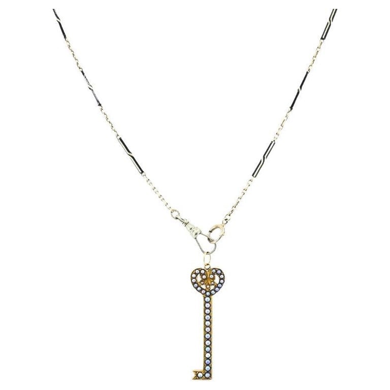 14k Gold Key Pendant Necklace Pearls and Black Enamel: Title: 14k Gold Key Pendant Necklace Pearls and Black Enamel Description: Materials: 14k Gold, Enamel Weight: 9.6 Grams Gemstone: Pearl Measurement: Pendant - 1/2" x 1 1/2" Chain - 13 1/2" Hallmarks: 