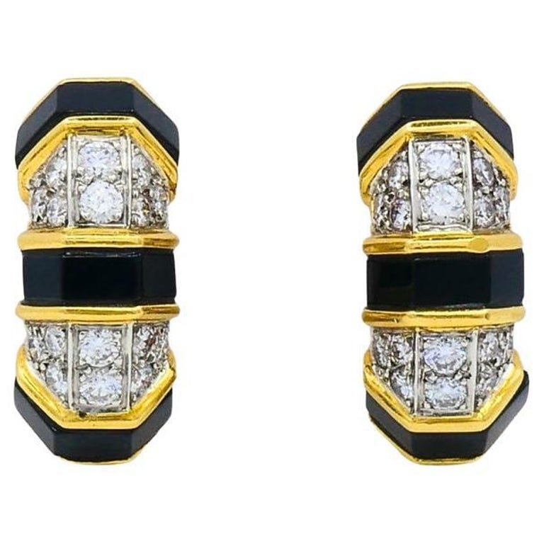 Tiffany & Co. 18k Gold Onyx Diamond Hoop Earrings: Title: Tiffany & Co. 18k Gold Onyx Diamond Hoop Earrings Description: DESIGNER: Tiffany & Co. CIRCA: 1980s MATERIALS: 18K Yellow Gold GEMSTONE: Onyx, Diamond WEIGHT: 15.3 Grams MEASUREMENT: 3/8"