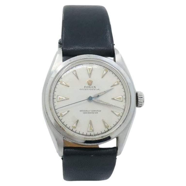Vintage Rolex Oyster Perpetual 6084 Stainless Steel Wristwatch c. 1950s: Title: Vintage Rolex Oyster Perpetual 6084 Stainless Steel Wristwatch c. 1950s Description: Crafted in stainless steel, this vintage Rolex Oyster Perpetual 6084 has a silver tone dial. The