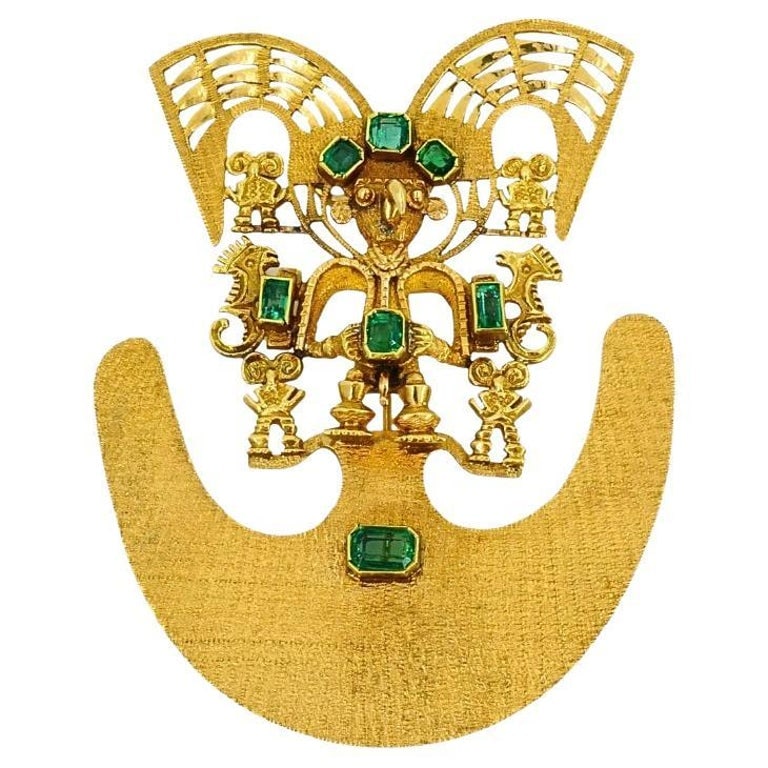 18k Gold Brooch/Pendant Emeralds Pre-Columbian Jewelry: Title: 18k Gold Brooch/Pendant Emeralds Pre-Columbian Jewelry Description: An impressive 18k gold brooch with emeralds. The piece features a central figure with outstretched wings, possibly