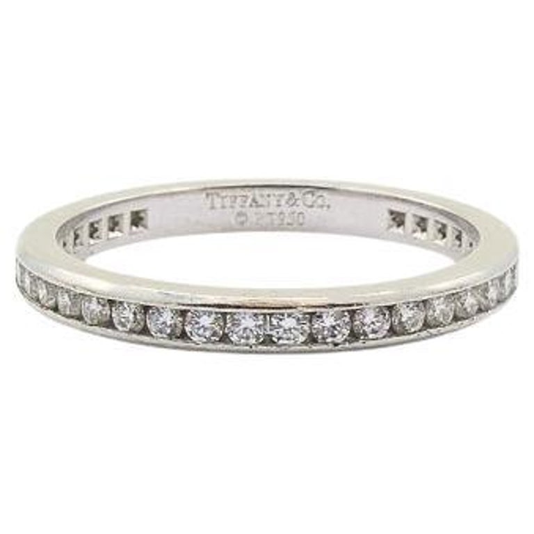 Tiffany & Co. Wedding Band Platinum Diamond Ring: Title: Tiffany & Co. Wedding Band Platinum Diamond Ring Description: A classic Tiffany & Co. wedding band, made of platinum and diamond. The ring features a row of round brilliant-cut diamonds, channe