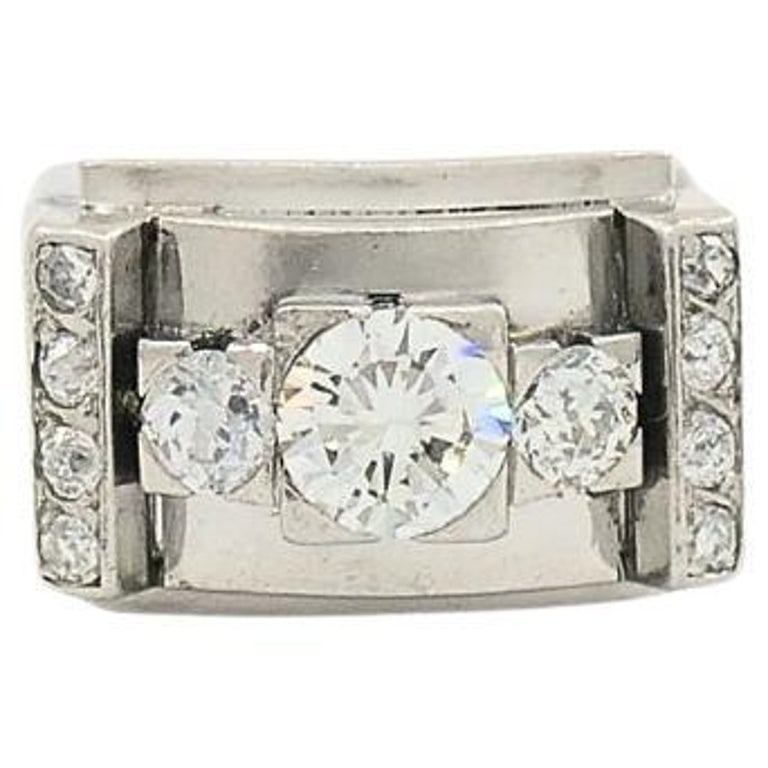 Vintage Platinum Diamond Ring Tank Design: Title: Vintage Platinum Diamond Ring Tank Design Description: A vintage platinum diamond ring featuring a tank design. The diamonds include round brilliant and single cuts, with three central diamonds