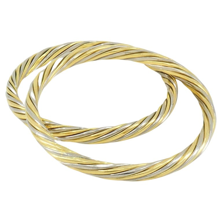Vintage Van Cleef & Arpels Two-Tone Gold Pair of Bangles: Title: Vintage Van Cleef & Arpels Two-Tone Gold Pair of Bangles Description: A gorgeous pair of vintage Van Cleef & Arpels bangle bracelets made of 18k white and yellow gold. It's designed as alternat