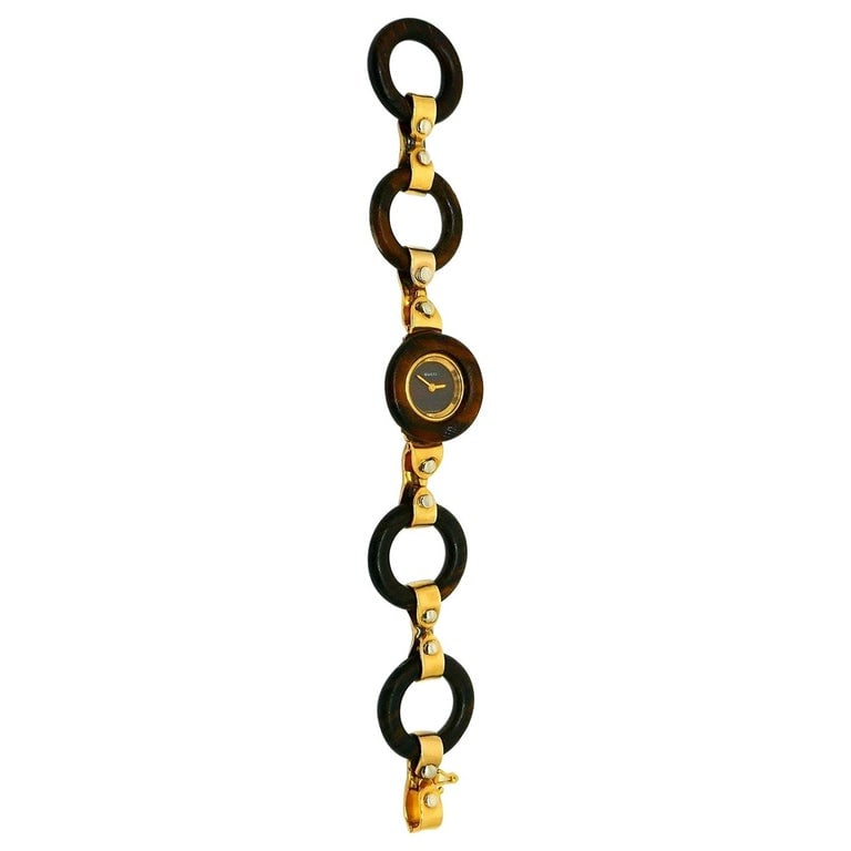 Vintage Gucci Yellow Gold Wood Circle Link Bracelet Watch: Title: Vintage Gucci Yellow Gold Wood Circle Link Bracelet Watch Description: Classic Gucci equestrian design embodied in a lightweight wooden and 18k yellow gold bracelet. This Switch watch is a grea