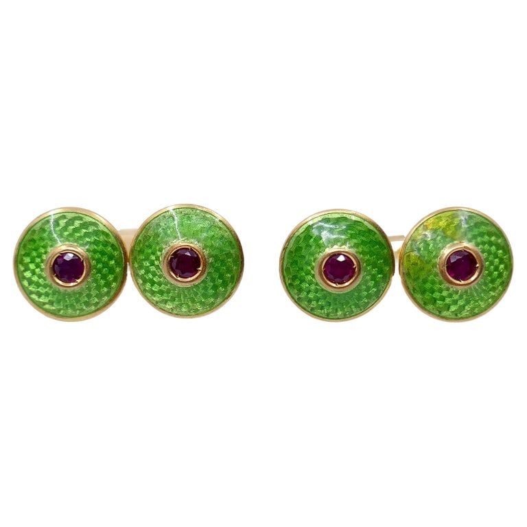 French Guilloche Enamel Ruby Cuff links: Title: French Guilloche Enamel Ruby Cuff links Description: These French cufflinks, crafted in the 1930s, showcase a vibrant and sophisticated design. Made with 18K gold, the cufflinks feature a brigh