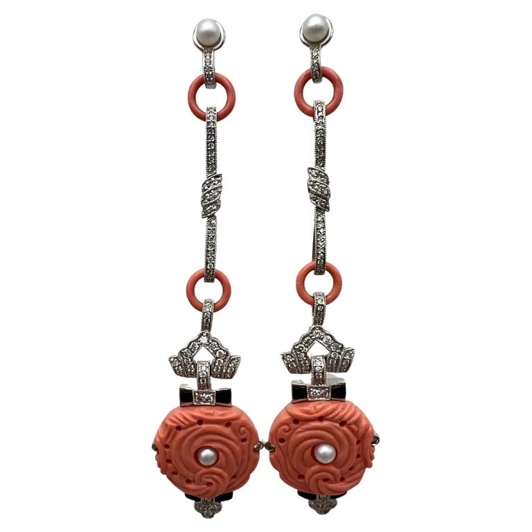 Art Deco White Gold Coral Diamond Pearl and Enamel Dangle Earrings: Title: Art Deco White Gold Coral Diamond Pearl and Enamel Dangle Earrings Description: Product details: The earrings are made out of 18K white gold, carved coral, 1.34 ct of round brilliant cut diamon