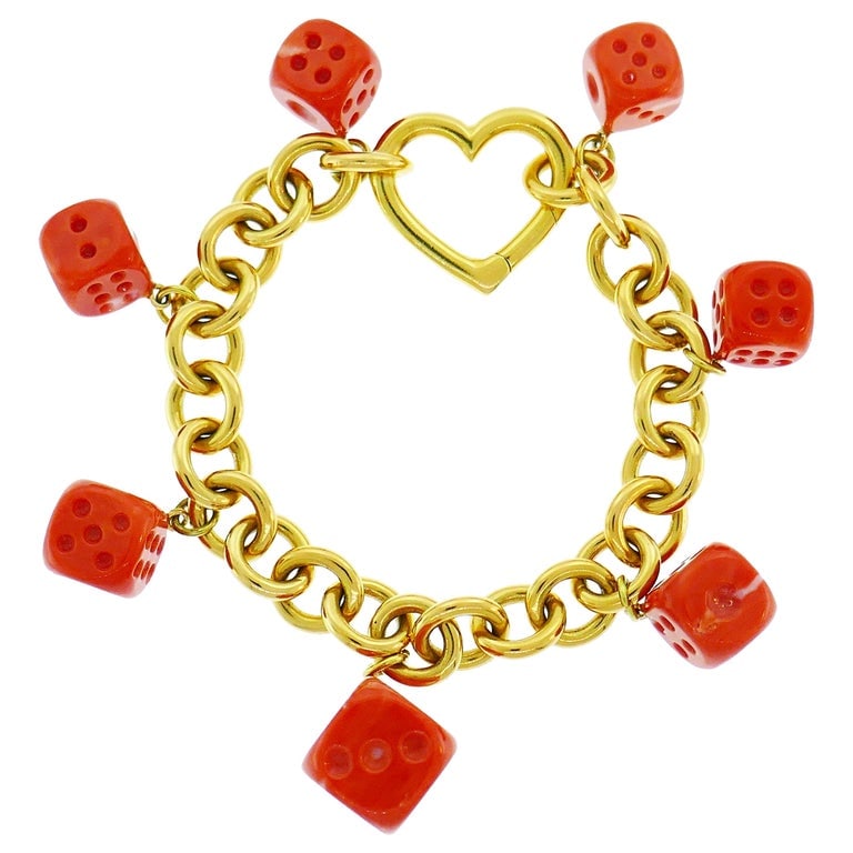 Tiffany & Co. Yellow Gold Coral Dice Charm Bracelet: Title: Tiffany & Co. Yellow Gold Coral Dice Charm Bracelet Description: Lovely Tiffany & Co. bracelet with Mediterranean coral dice charms. Wearable and fun, the bracelet is a great addition to your