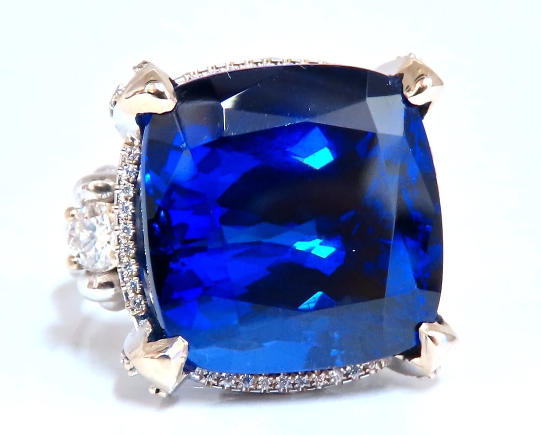 GIA Certified 27.35ct natural Blue Tanzanite diamonds ring 18kt Three Stone: Title: GIA Certified 27.35ct natural Blue Tanzanite diamonds ring 18kt Three Stone Description: Royal Raised Three stone Tanzanite Ring. GIA Certified: 27.35ct. Natural tanzanite Cushion cut Excellent