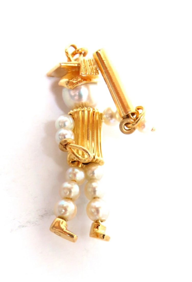 Pearl graduation charm 14kt gold: Title: Pearl graduation charm 14kt gold Description: Graduation charm 3 mm natural akoya pearls Overall: 26 x 13mm 14 karat gold 3.3 grams ....*. Reserve: $552.00 Shipping: