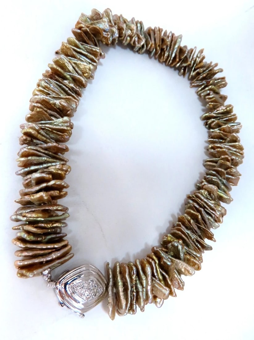 20 mm baroque off shape Pearl necklace 14kt gold diamond clasp: Title: 20 mm baroque off shape Pearl necklace 14kt gold diamond clasp Description: 20 mm off shape stranded baroque Pearl necklace .50 carat natural round diamonds on clasp H color si-1 clarity Clasp