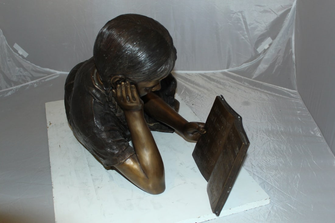 Girl laying reading a book Bronze Statue - Size: 36"L x 17"W x 18"H. - 11
