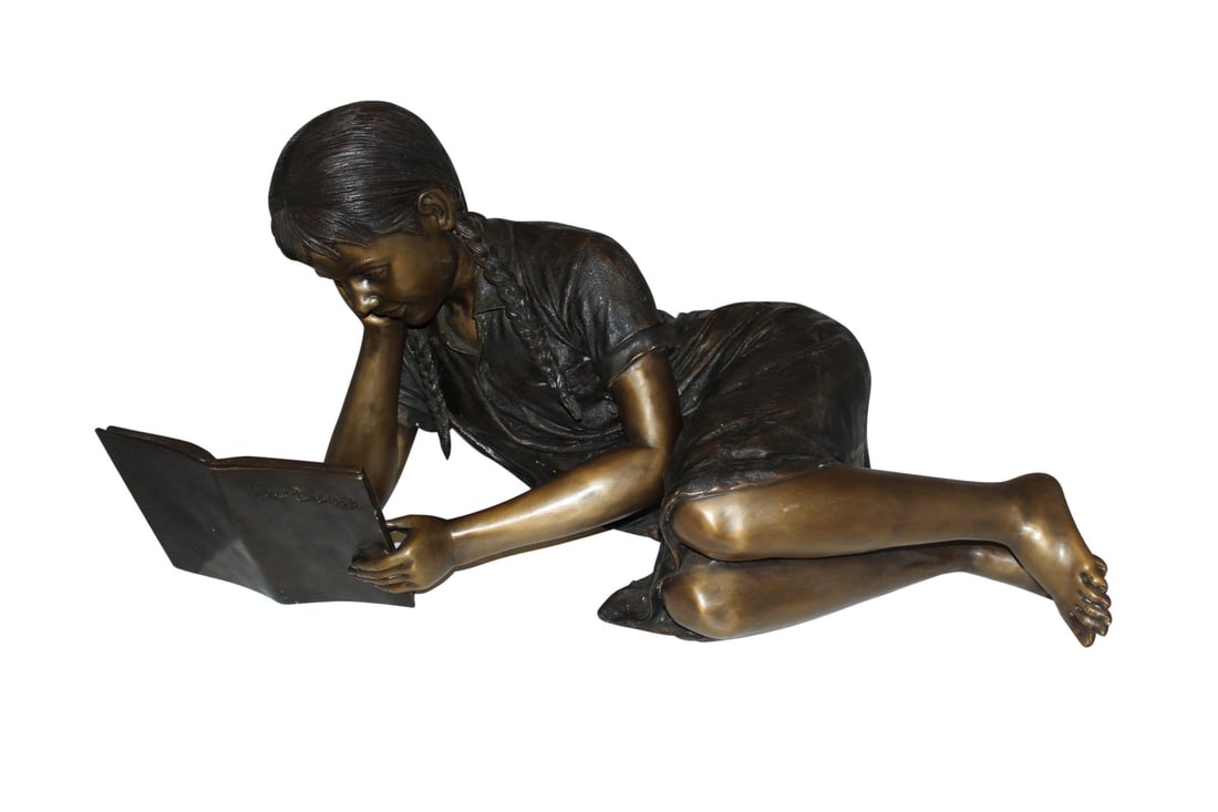 Girl laying reading a book Bronze Statue - Size: 36"L x 17"W x 18"H.: Title:Girl laying reading a book Bronze Statue - Size: 36"L x 17"W x 18"H. Description:Magnificent large size bronze of a girl laying down outside and reading a book. The joy of youth, lost in a book