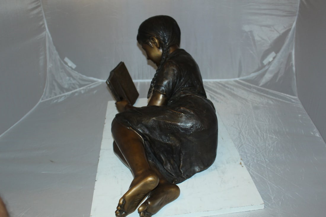 Girl laying reading a book Bronze Statue - Size: 36"L x 17"W x 18"H. - 7