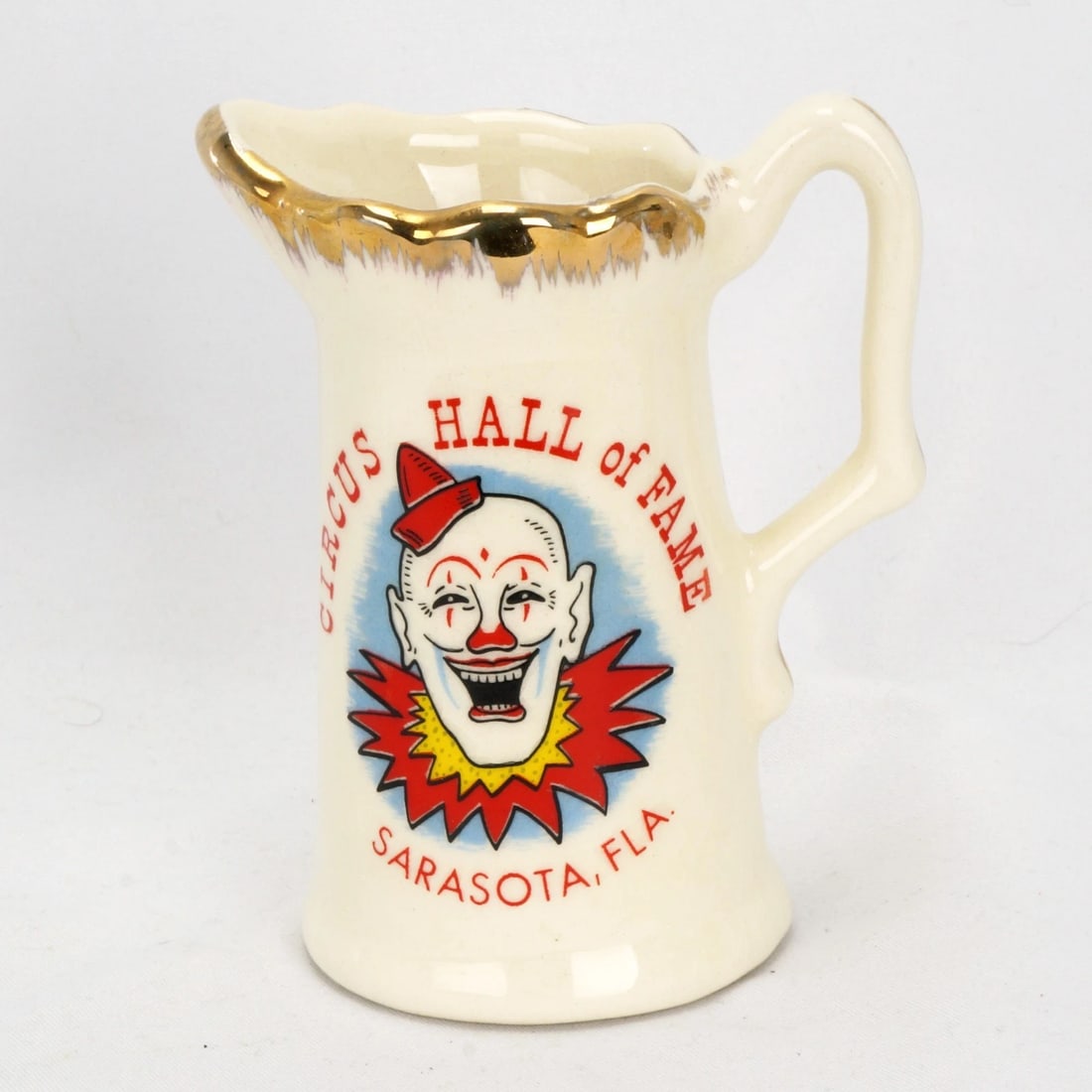 1950s Circus Hall of Fame Clown Creamer: Title:1950s Circus Hall of Fame Clown Creamer Size:3 3/4 in (9.5 cm) tall x 2 1/4 in (5.7 cm) diameter. Description:A colorful and nostalgic vintage souvenir creamer from the Sarasota Florida Circus H