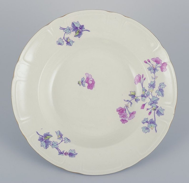 Gustafsberg, Sweden. A set of six deep 'Geranium' earthenware plates. 1918. - 2