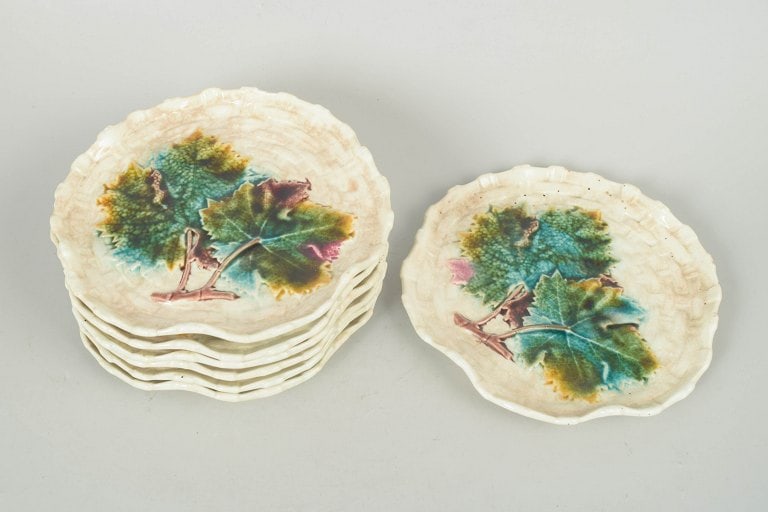 Gustavsberg, Sweden. Majolica set of seven plates with relief moulded and floral decoration . Circa - 2