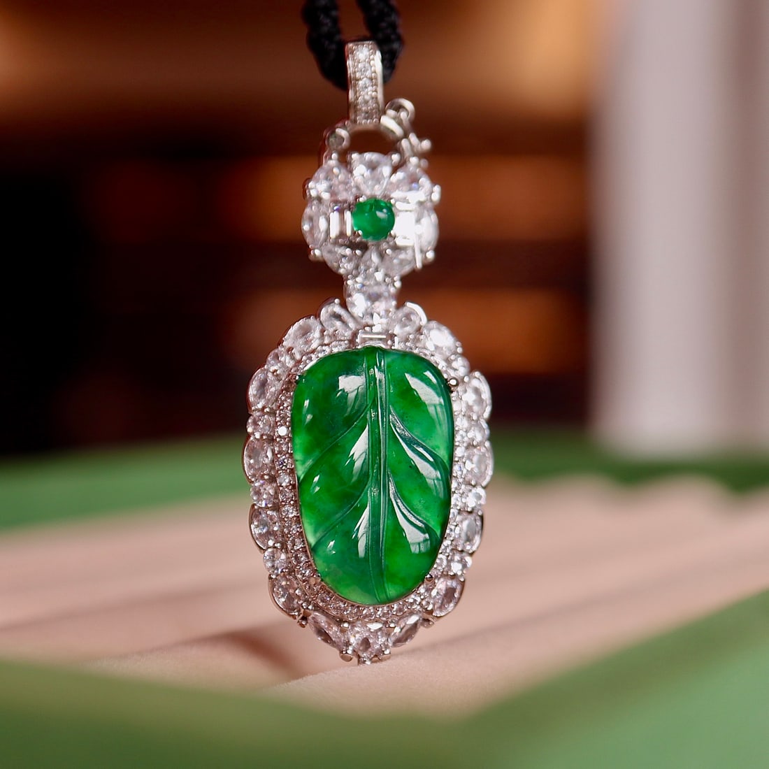 Natural Jadeite Pendant: Title: Natural Jadeite Pendant Description: This natural jadeite pendant showcases a noble and elegant aura with its imperial green hue. The jadeite of Dragon Stone type is full of water, simple yet