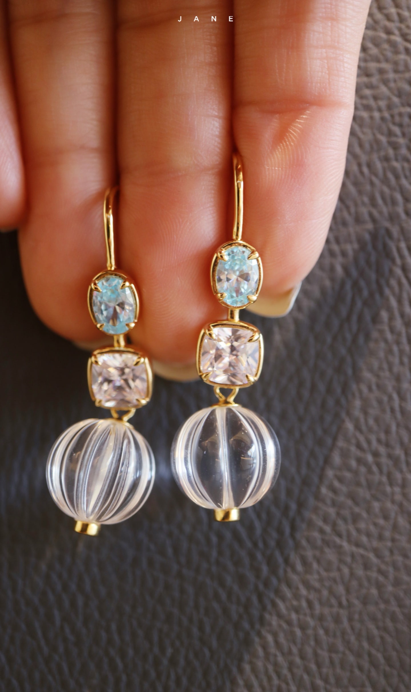 Sterling Silver Natural White Crystal Earrings: Title: Sterling Silver Natural White Crystal Earrings Description: These earrings feature natural white crystals as the main stones, complemented by colorful zircon, showcasing unique elegance and cha