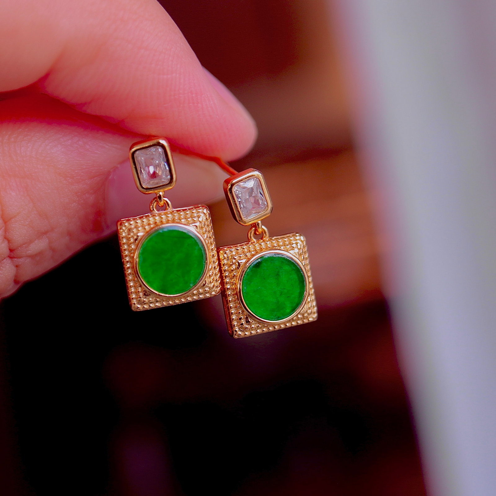 Natural Jade Stud Earrings: Title: Natural Jade Stud Earrings Description: These stud earrings feature natural jade as the main stone, showcasing a classic round design. The S925 silver setting, adorned with cubic zirconia,