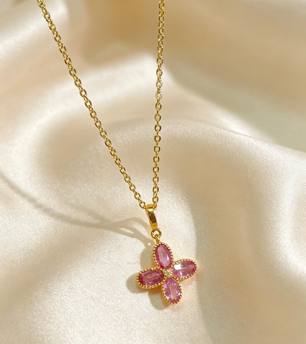 18K Gold Pink Sapphire Pendant: Title: 18K Gold Pink Sapphire Pendant Description: This 18K gold pendant is set with a charming pink sapphire, showcasing a perfect blend of elegance and sophistication. Its design is simple yet luxur
