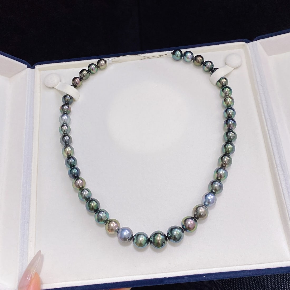 Tahitian Pearl Necklace: Title: Tahitian Pearl Necklace Description: Tahitian pearls are renowned for their unique luster and nearly round shape with slight blemishes. Each pearl displays charming overtones, perfect for