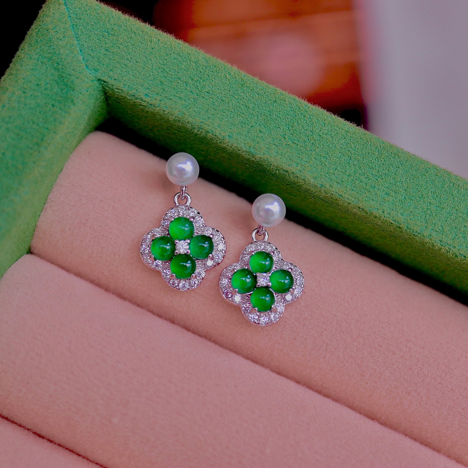 Natural Jade Earrings: Title: Natural Jade Earrings Description: These earrings feature a classic four-leaf clover design, symbolizing luck and prosperity. The jade is vividly green with a rich hue and full transparency,