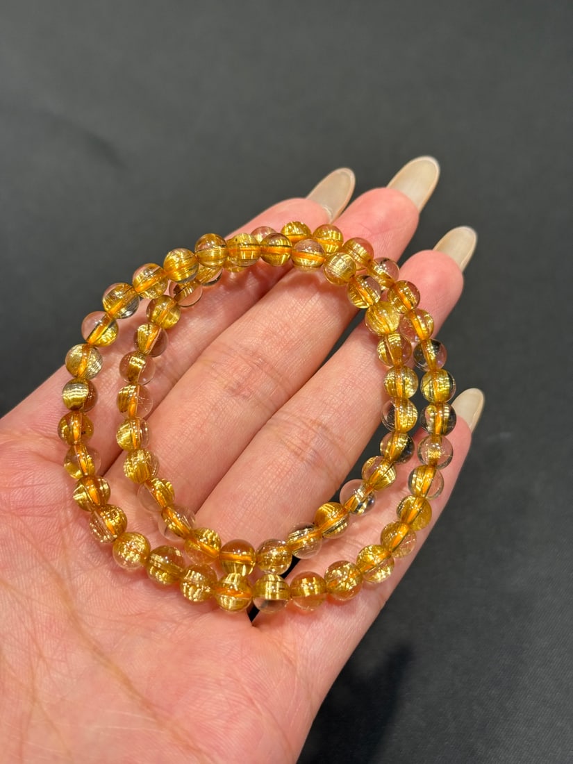 Natural Rutilated Quartz Bracelet: Title: Natural Rutilated Quartz Bracelet Description: This natural rutilated quartz bracelet is renowned for its clean crystals and golden hue. The double-circle design is not only aesthetically