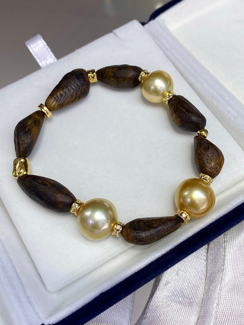 South Sea Golden Pearl Bracelet: Title: South Sea Golden Pearl Bracelet Description: This bracelet features South Sea golden pearls paired with agarwood, showcasing unique elegance and luxury. Each pearl is carefully selected,