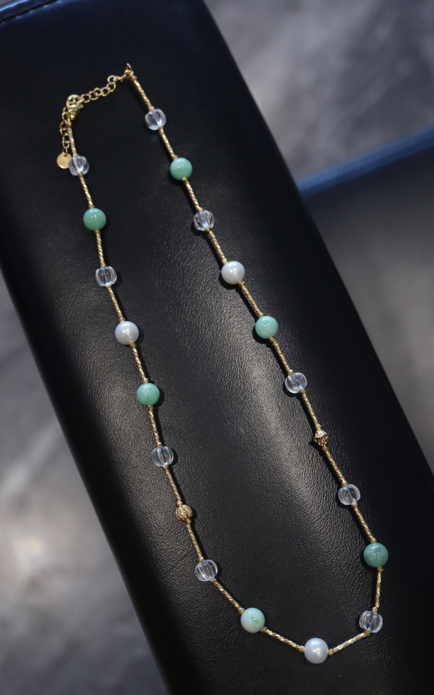 Sterling Silver White Crystal and Turquoise Necklace: Title: Sterling Silver White Crystal and Turquoise Necklace Description: This necklace features white crystal and turquoise, interspersed with bean-green jadeite beads and lustrous pearls. The