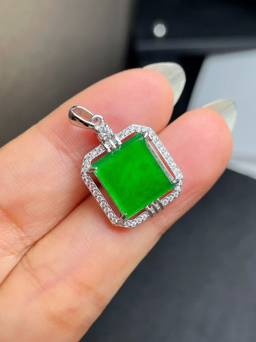 Silver Natural Jadeite Pendant: Title: Silver Natural Jadeite Pendant Description: This jadeite pendant features a minimalist yet elegant square design. The vivid green color and substantial texture make it irresistible. Perfect