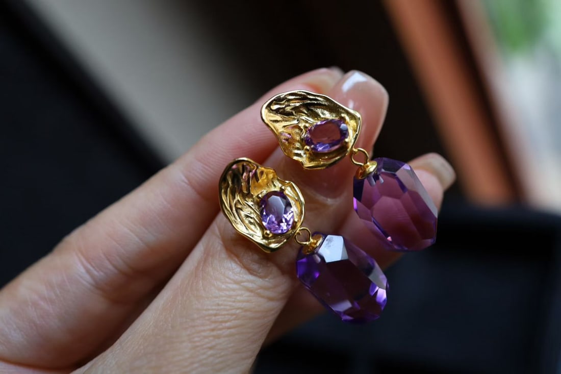 Natural Amethyst Earrings: Title: Natural Amethyst Earrings Description: These earrings showcase the natural allure of amethyst, with bright crystals and captivating color. The sterling silver surface is matte-finished,