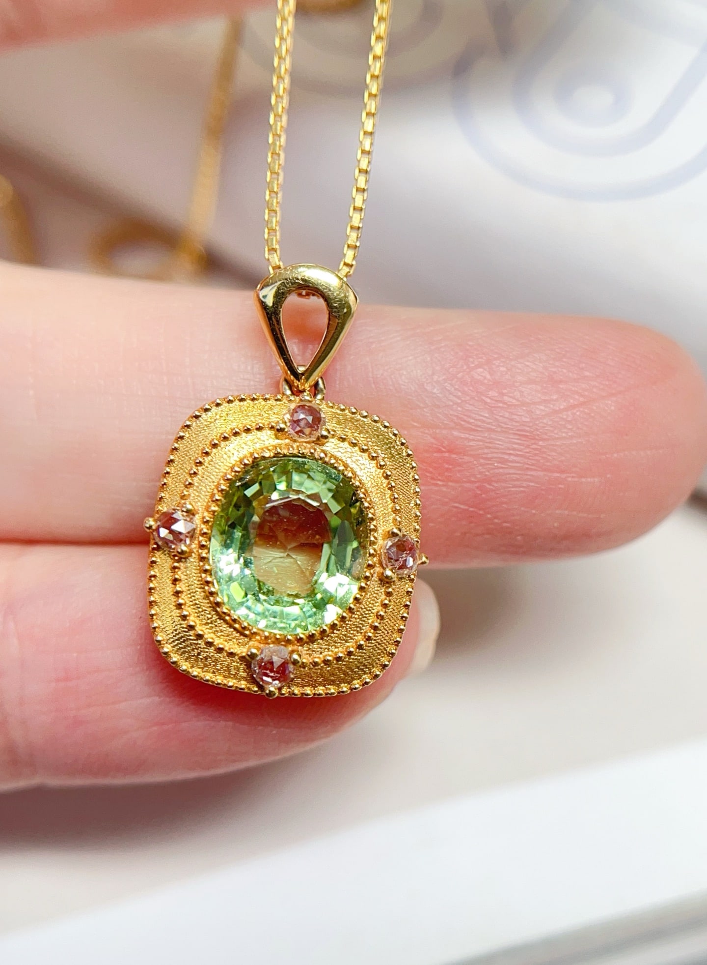 18K Gold Tourmaline Pendant: Title: 18K Gold Tourmaline Pendant Description: This pendant is meticulously crafted in 18K gold, featuring a completely clean tourmaline with a unique mint green luster. Four white sapphires add an e