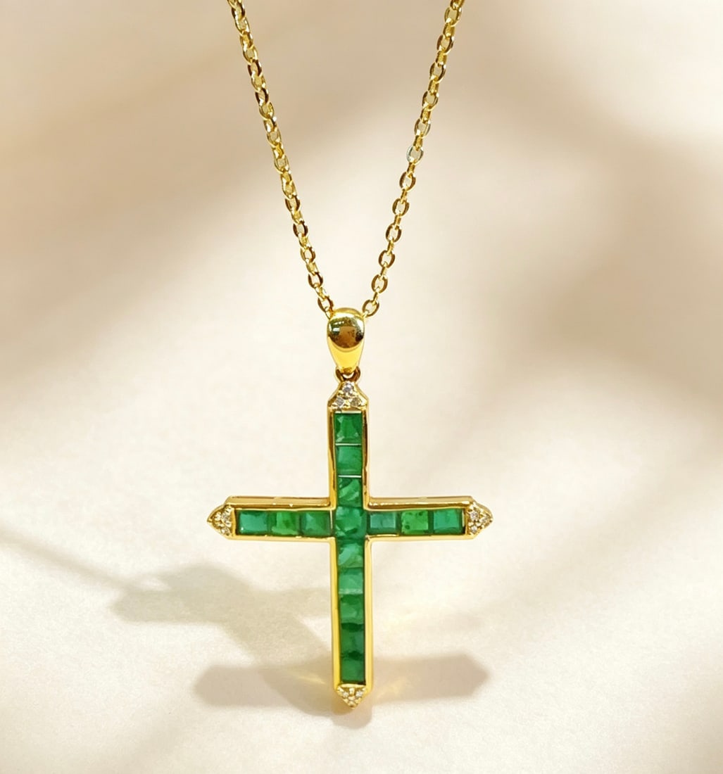 Emerald Cross Pendant: Title: Emerald Cross Pendant Description: This emerald cross pendant showcases a unique sense of fashion, with a table design that makes it appear particularly grand. Lightweight and comfortable to