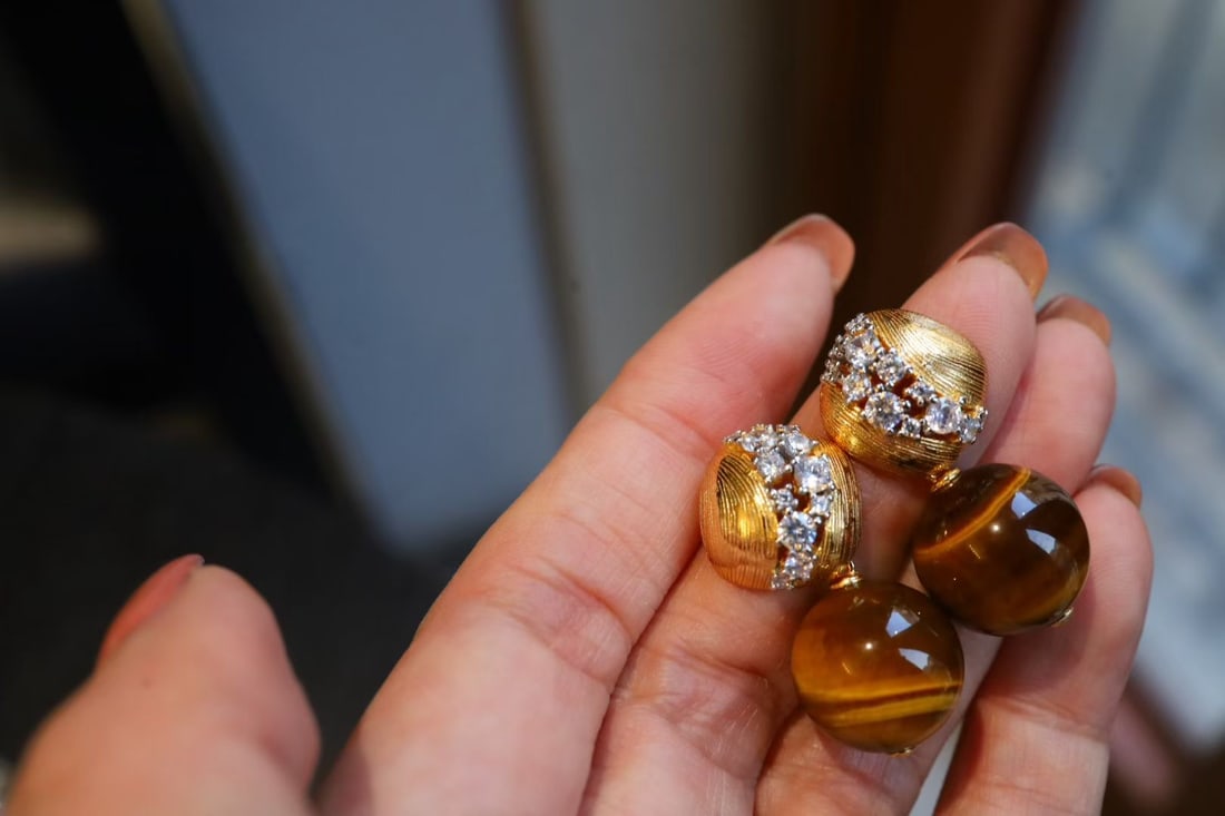 Tiger's Eye Earrings: Title: Tiger's Eye Earrings Description: These earrings feature tiger's eye stones, showcasing a unique luster and texture. The silver plating ensures lasting color and brilliance. The design is