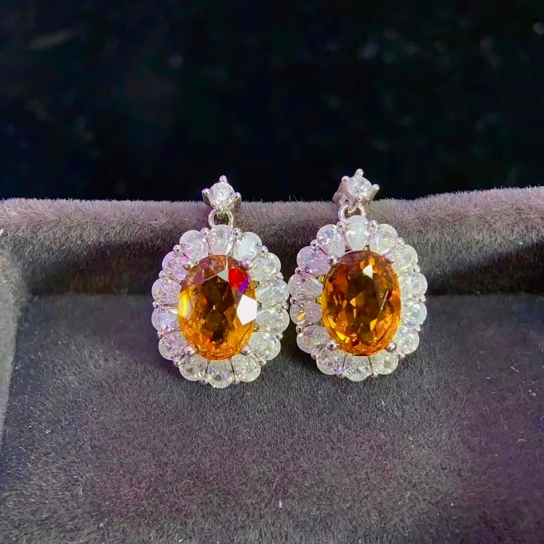 Citrine Earrings: Title: Citrine Earrings Description: These citrine earrings exhibit a warm, sunlit hue, meticulously set in 925 material with a pure and flawless crystal. Its natural color evokes the gentle warmth of