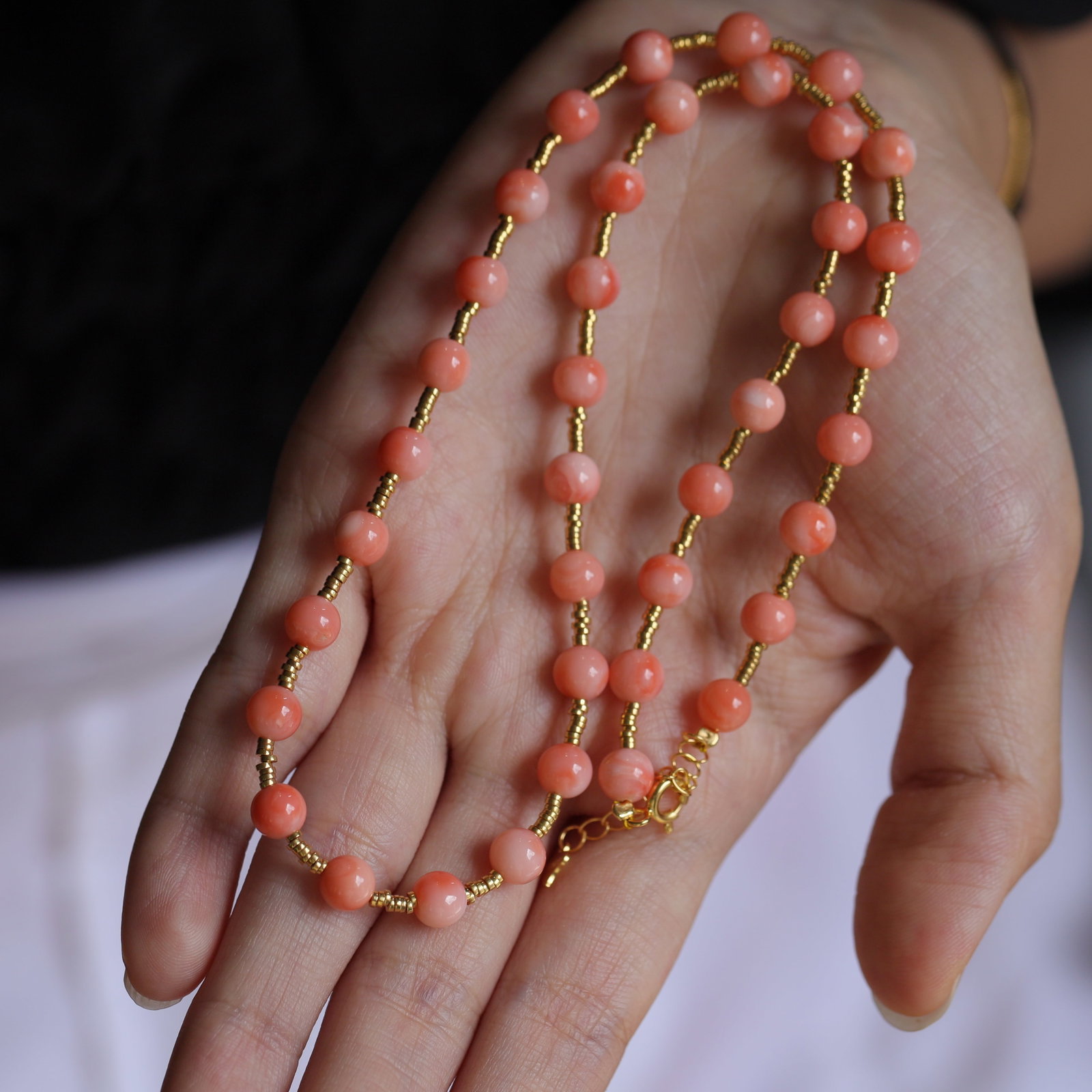 Natural Pink Coral Necklace: Title: Natural Pink Coral Necklace Description: This natural pink coral necklace exudes elegance with its soft hues. The delicate gold spacer beads and S925 silver fittings complement each other,