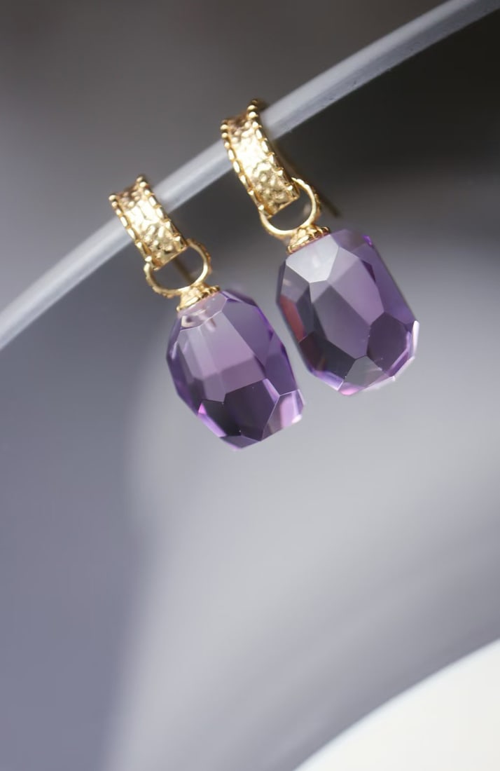 Sterling Silver Amethyst Earrings: Title: Sterling Silver Amethyst Earrings Description: These earrings feature an irregular freeform cut, breaking the symmetrical constraints of traditional faceted gemstones, showcasing a staggered